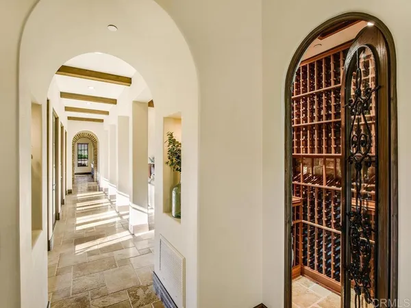 a view of a hallway with wooden floor and entryway