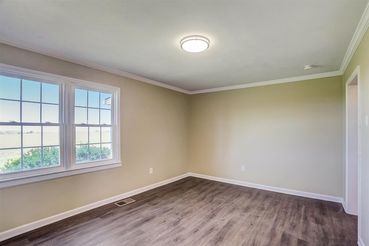 555 White Road Portland, TN 37148 - Photo 14 of 30 an empty room with wooden floor and windows