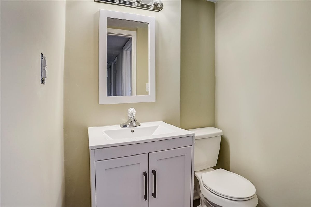 555 White Road Portland, TN 37148 - Photo 21 of 30 a bathroom with a toilet sink vanity and mirror