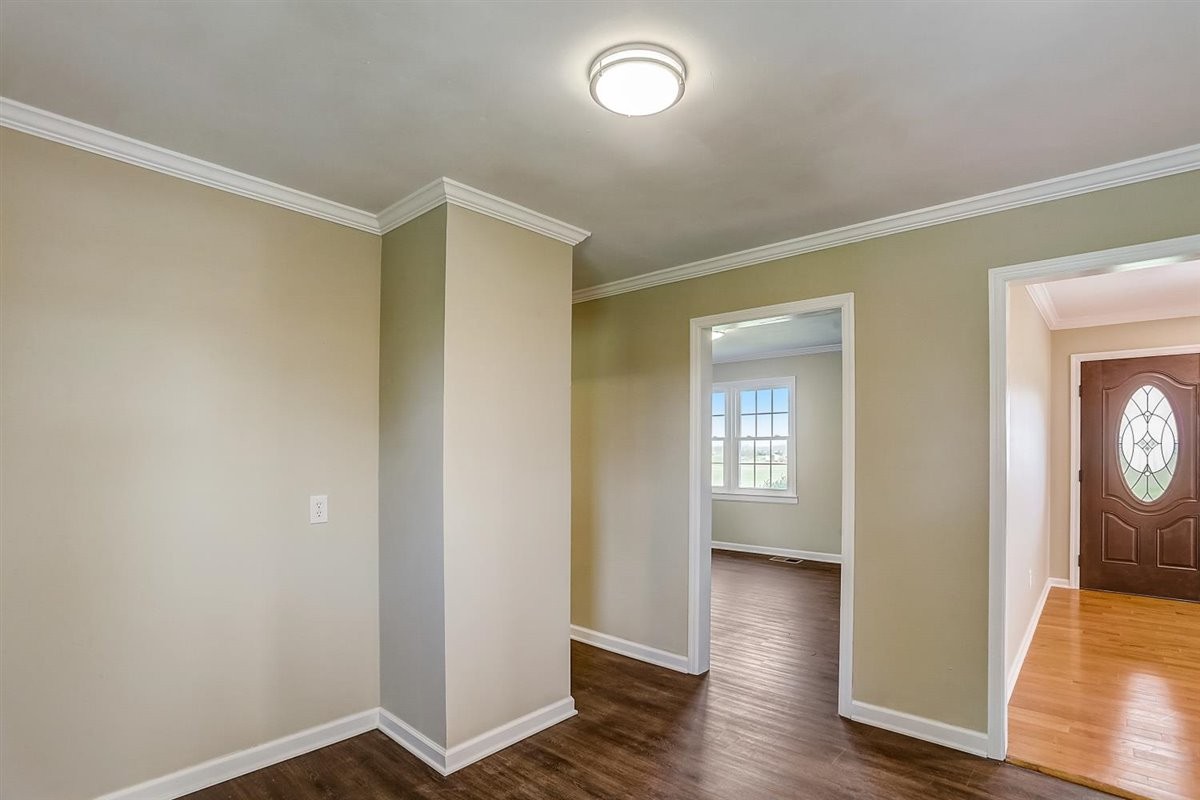 555 White Road Portland, TN 37148 - Photo 7 of 30 an empty room with wooden floor mirror and windows