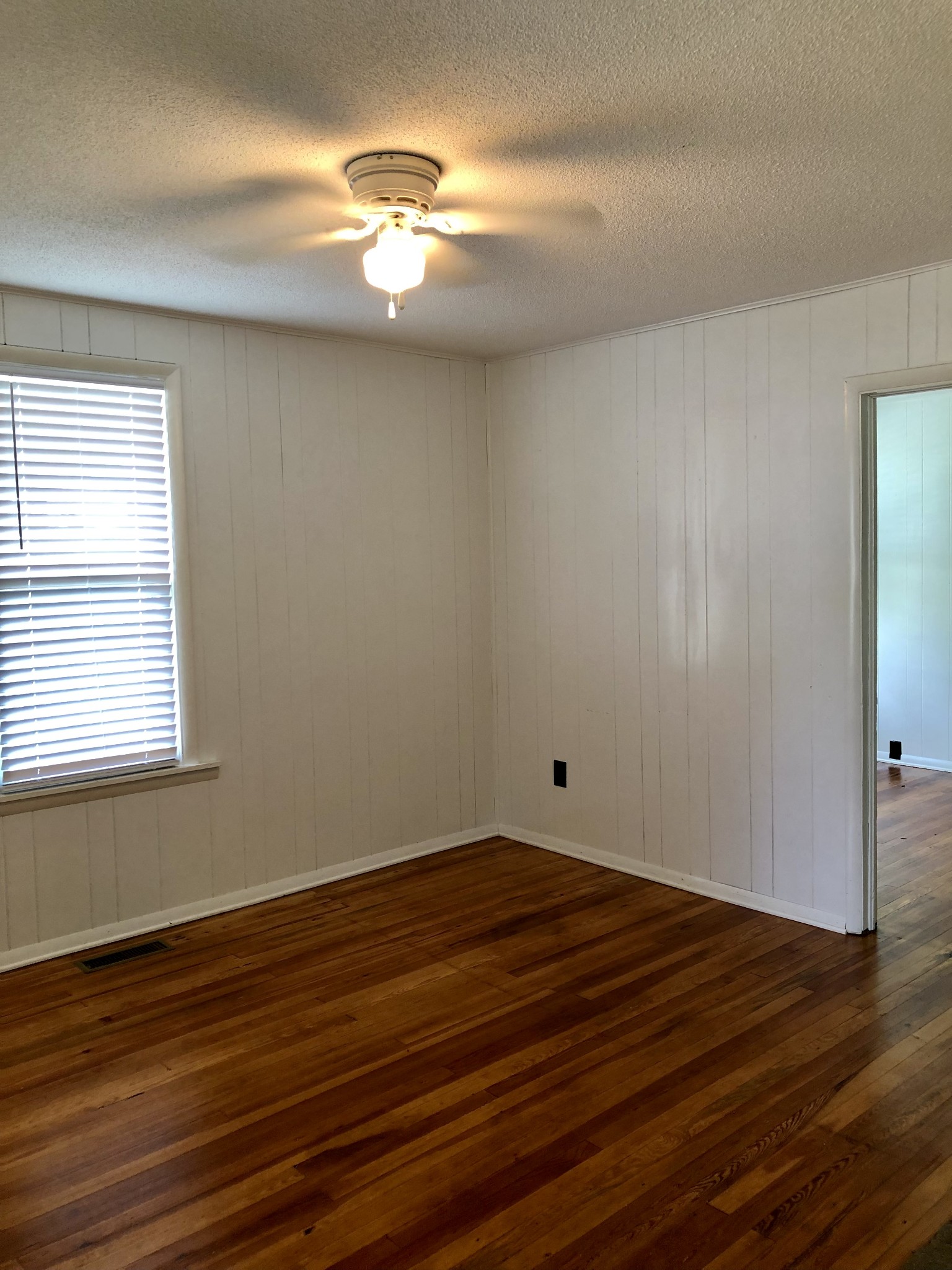629 A Fall River Road Lawrenceburg, TN 38464 - Photo 11 of 38 a view of an empty room with wooden floor and a window