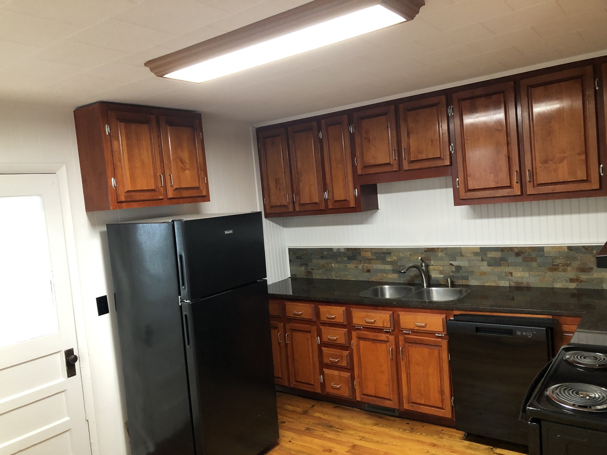 629 A Fall River Road Lawrenceburg, TN 38464 - Photo 20 of 38 a kitchen with granite countertop stainless steel appliances and refrigerator