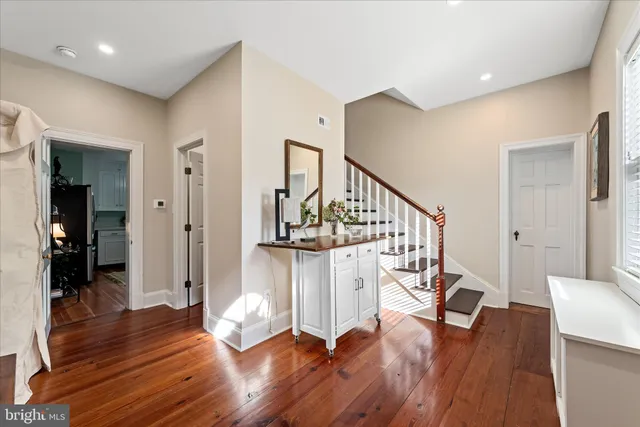 a view of entryway and hall with wooden floor