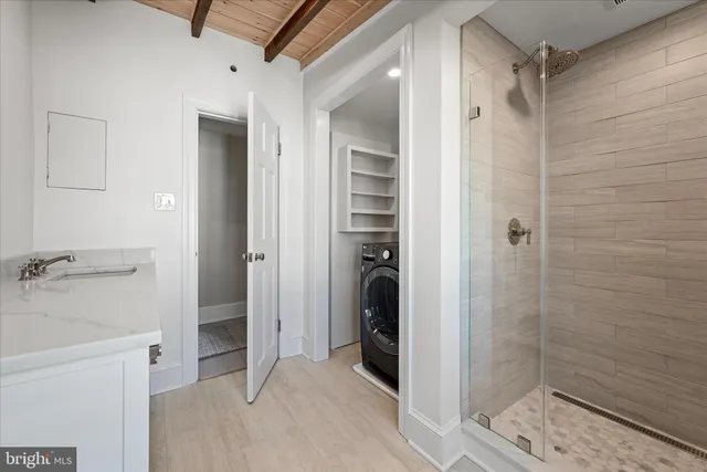 a bathroom with a shower and a sink