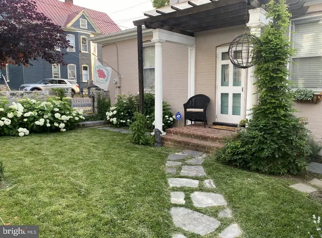 a front view of a house with a garden