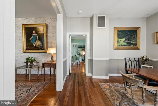 a view of a dining room with furniture wooden floor and a rug