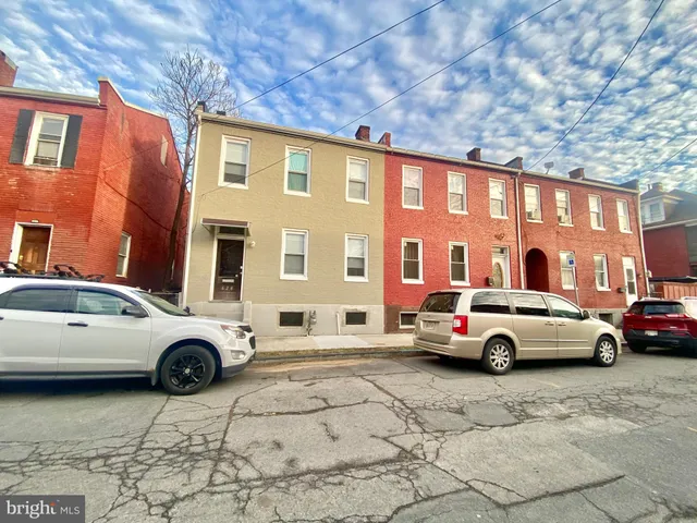 a view of a street with car parked