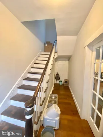 a view of staircase with wooden floor and chair