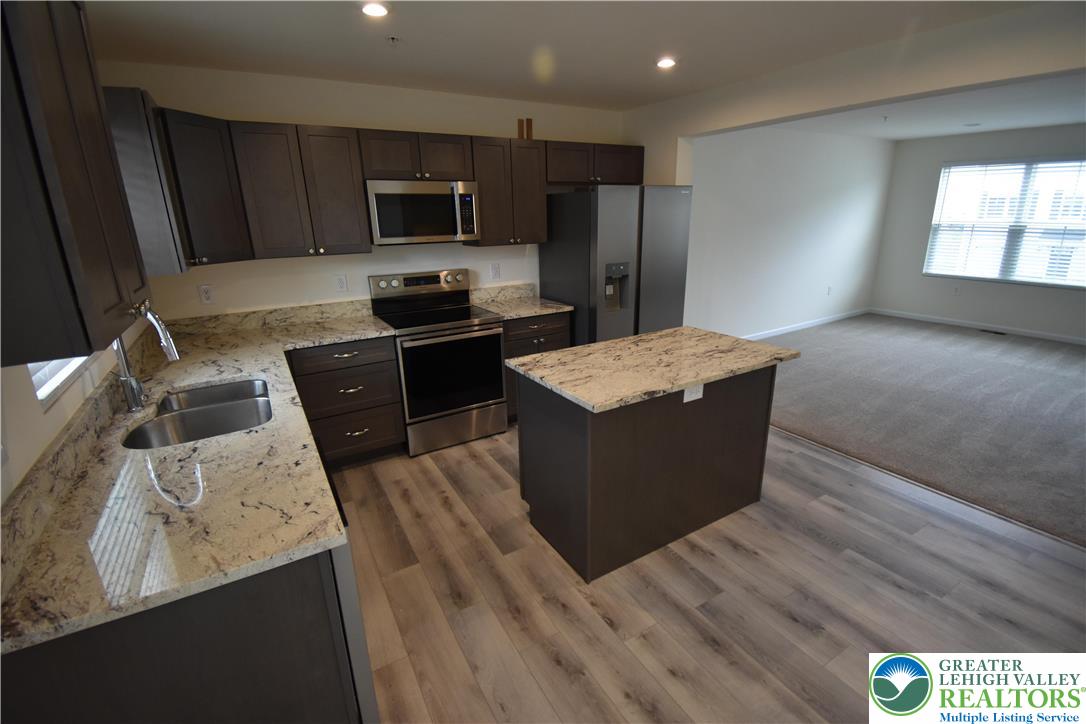 1924 Alex Road Easton, PA 18040 - Photo 5 of 22 a kitchen with a refrigerator stove a sink and dishwasher with wooden floor