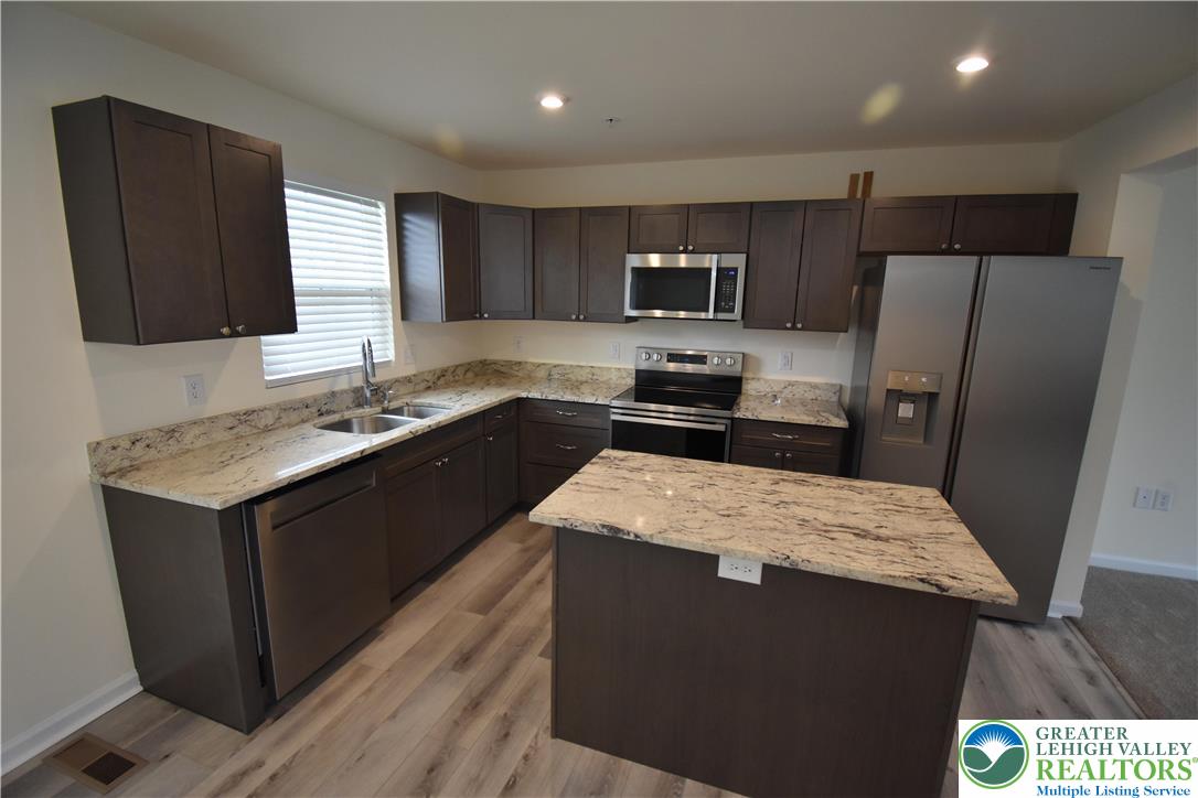 1924 Alex Road Easton, PA 18040 - Photo 6 of 22 a kitchen with stainless steel appliances granite countertop a sink stove and refrigerator