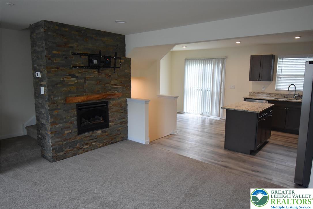 1924 Alex Road Easton, PA 18040 - Photo 9 of 22 a kitchen with stainless steel appliances granite countertop a stove a refrigerator and a fireplace
