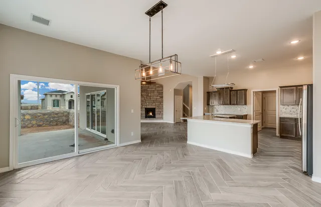 a large kitchen with stainless steel appliances lots of counter space and a refrigerator