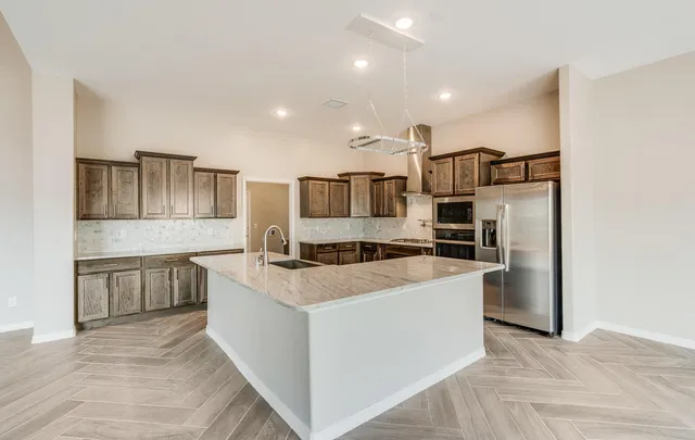 a bathroom with a granite countertop toilet and a sink