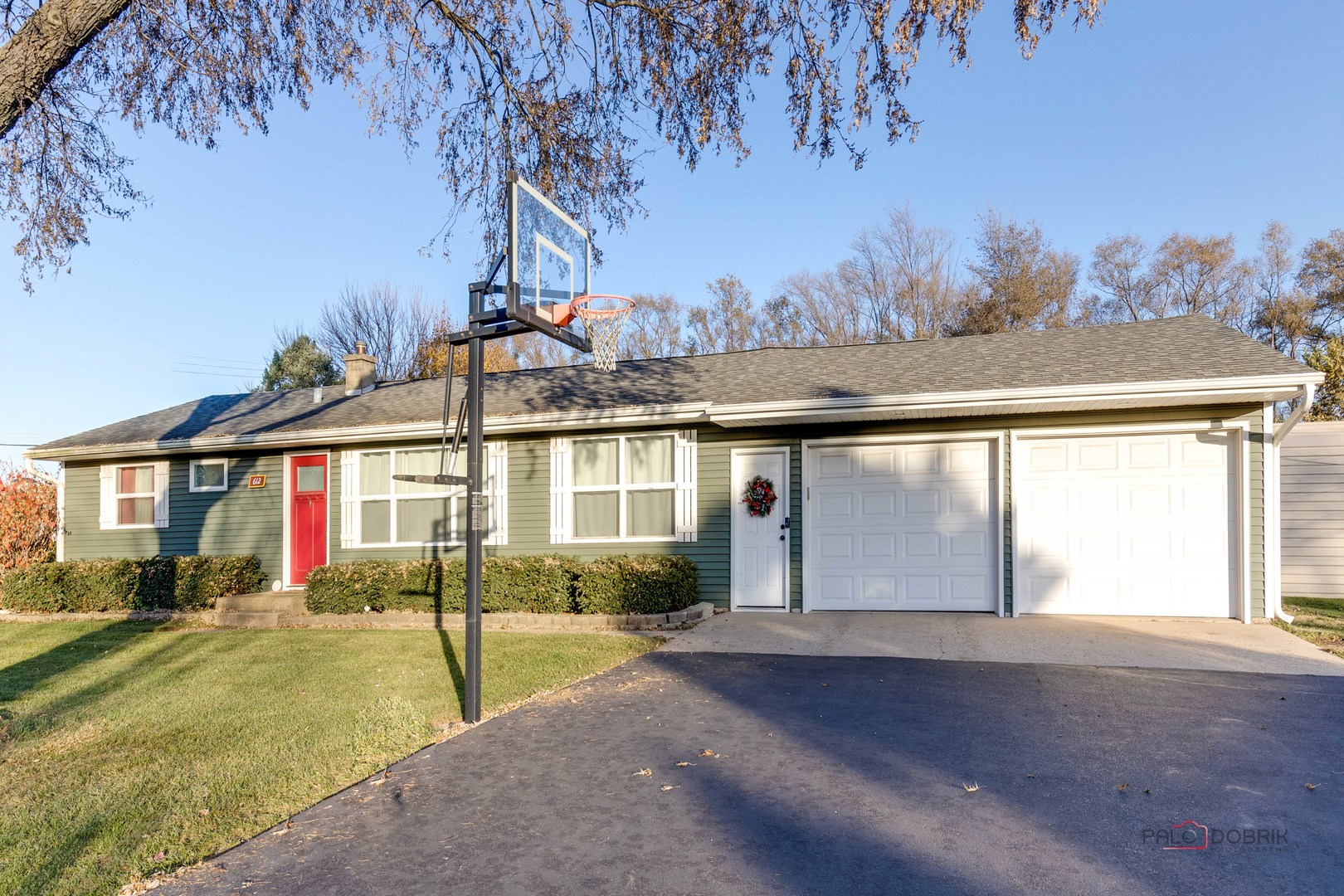 a view of a house with a yard and tree s