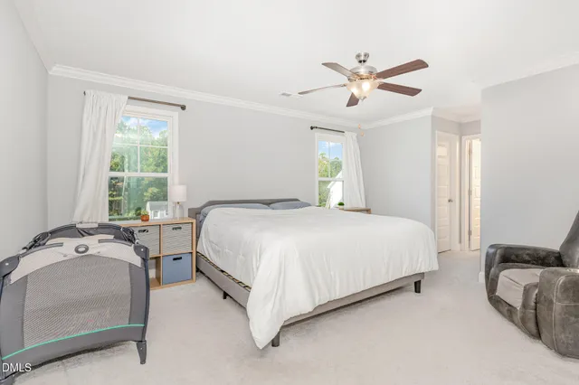 a spacious bedroom with a bed and window