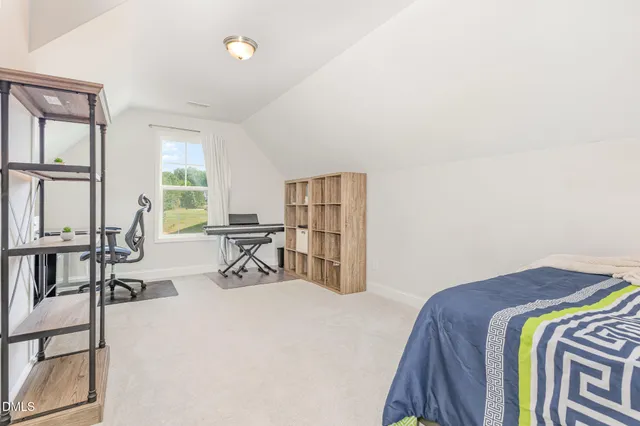 a view of a livingroom with furniture and a large window