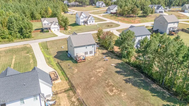an aerial view of a house with swimming pool and garden