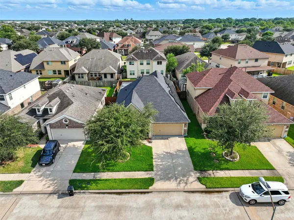 an aerial view of multiple houses with yard