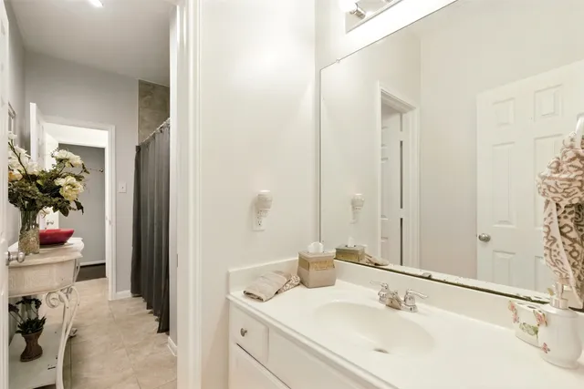 a bathroom with a sink vanity tub and shower