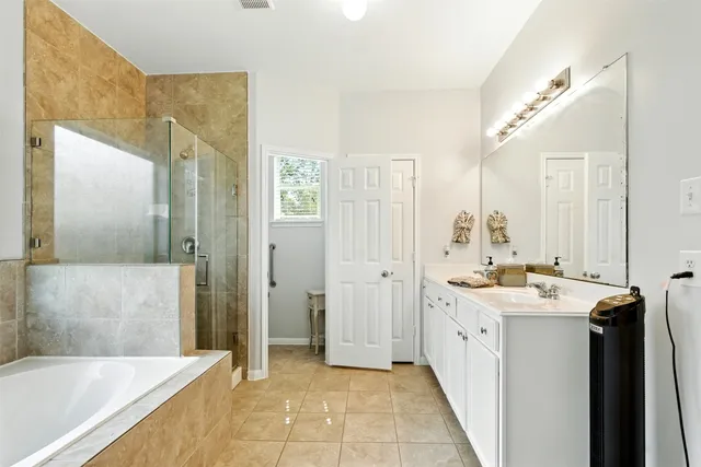 a bathroom with a tub sink and mirror