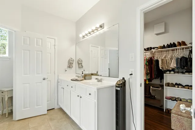 a bathroom with a sink a mirror and shower