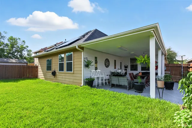 a view of house with a backyard