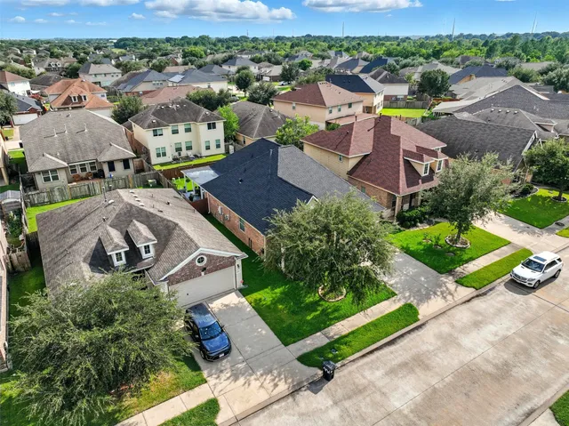 an aerial view of residential houses with outdoor space