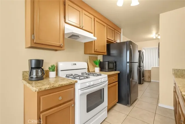 a kitchen with stainless steel appliances granite countertop a stove a refrigerator and a refrigerator