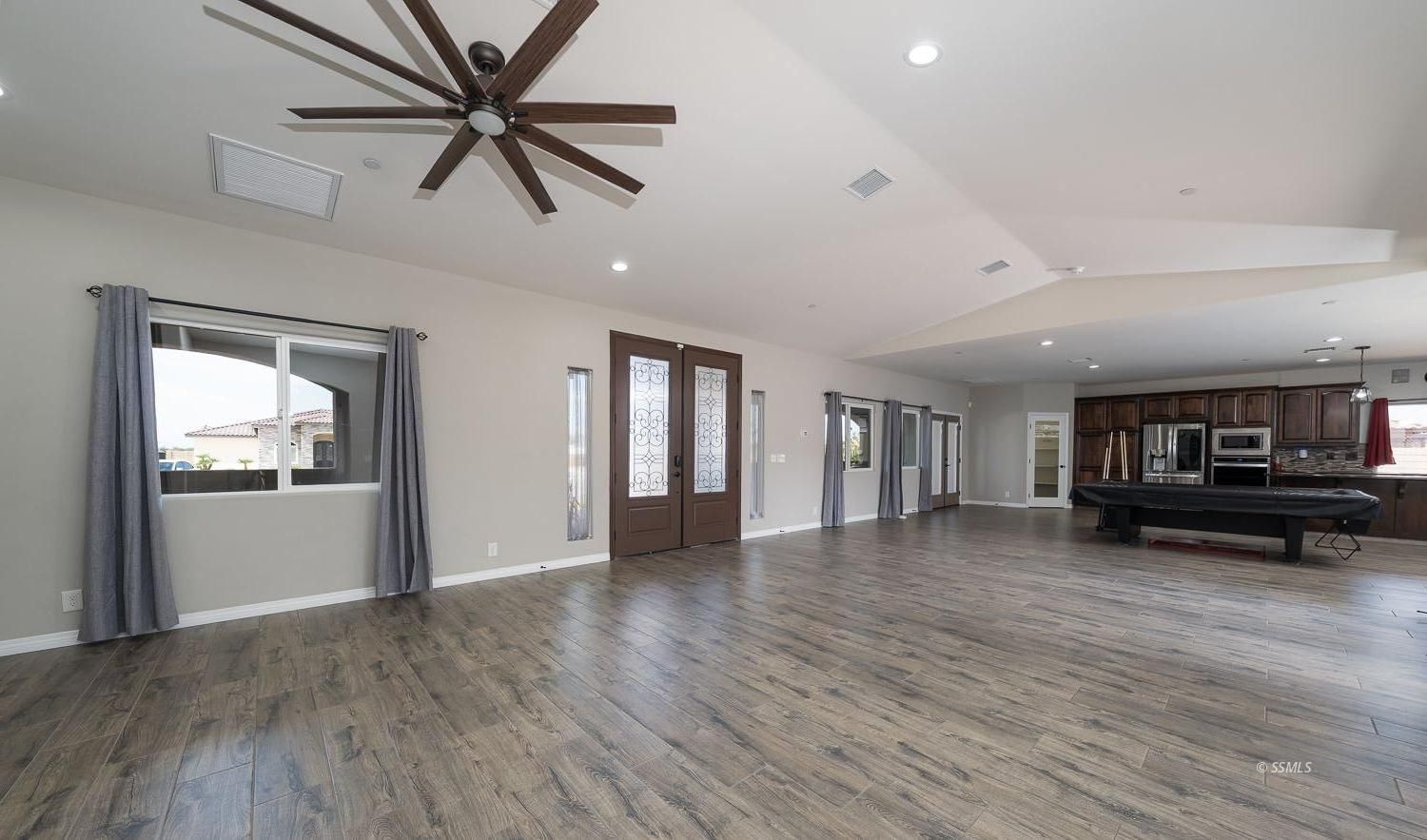 133 Rancho Del Cerro Ridgecrest, CA 93555 - Photo 5 of 50 a view of empty room with wooden floor and fan
