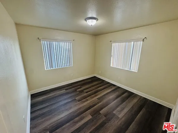 a view of room with wooden floor