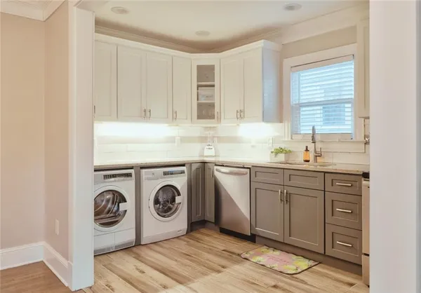 a utility room with sink dryer and washer