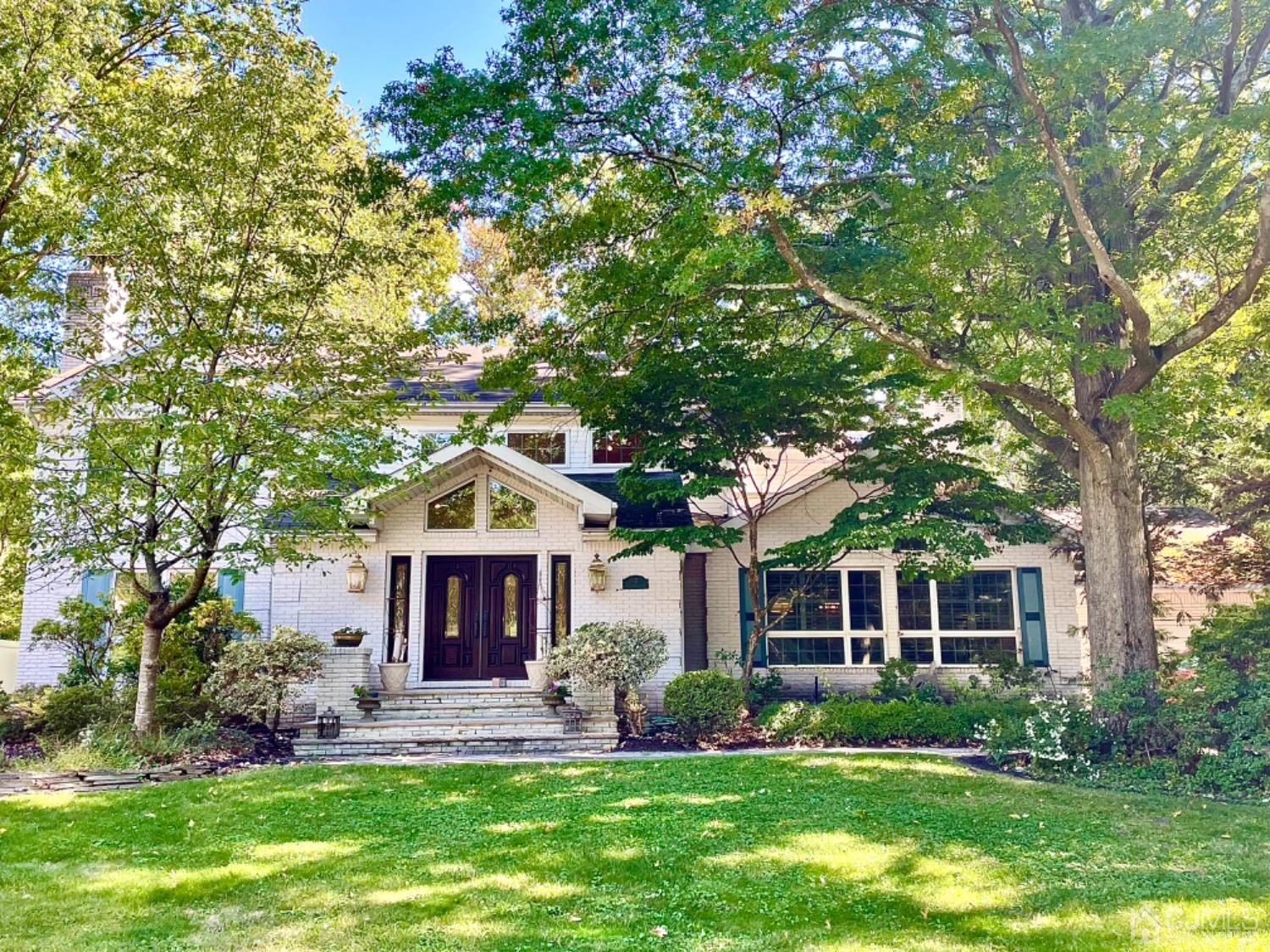 12 Clive Hills Road Edison, NJ 08820 - Photo 1 of 65 a front view of a house with a garden and trees