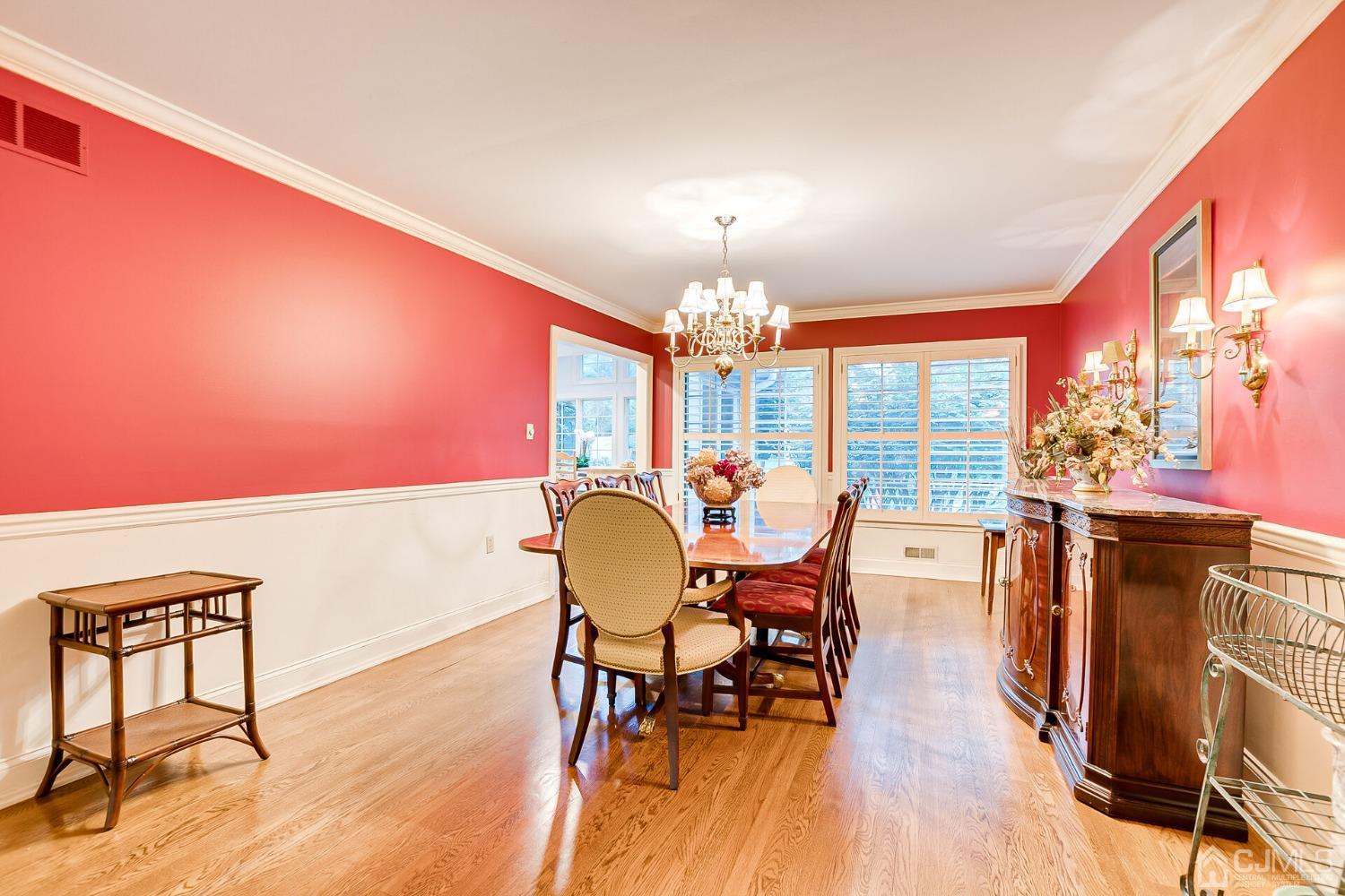 12 Clive Hills Road Edison, NJ 08820 - Photo 23 of 65 a view of a dining room with furniture a chandelier and wooden floor