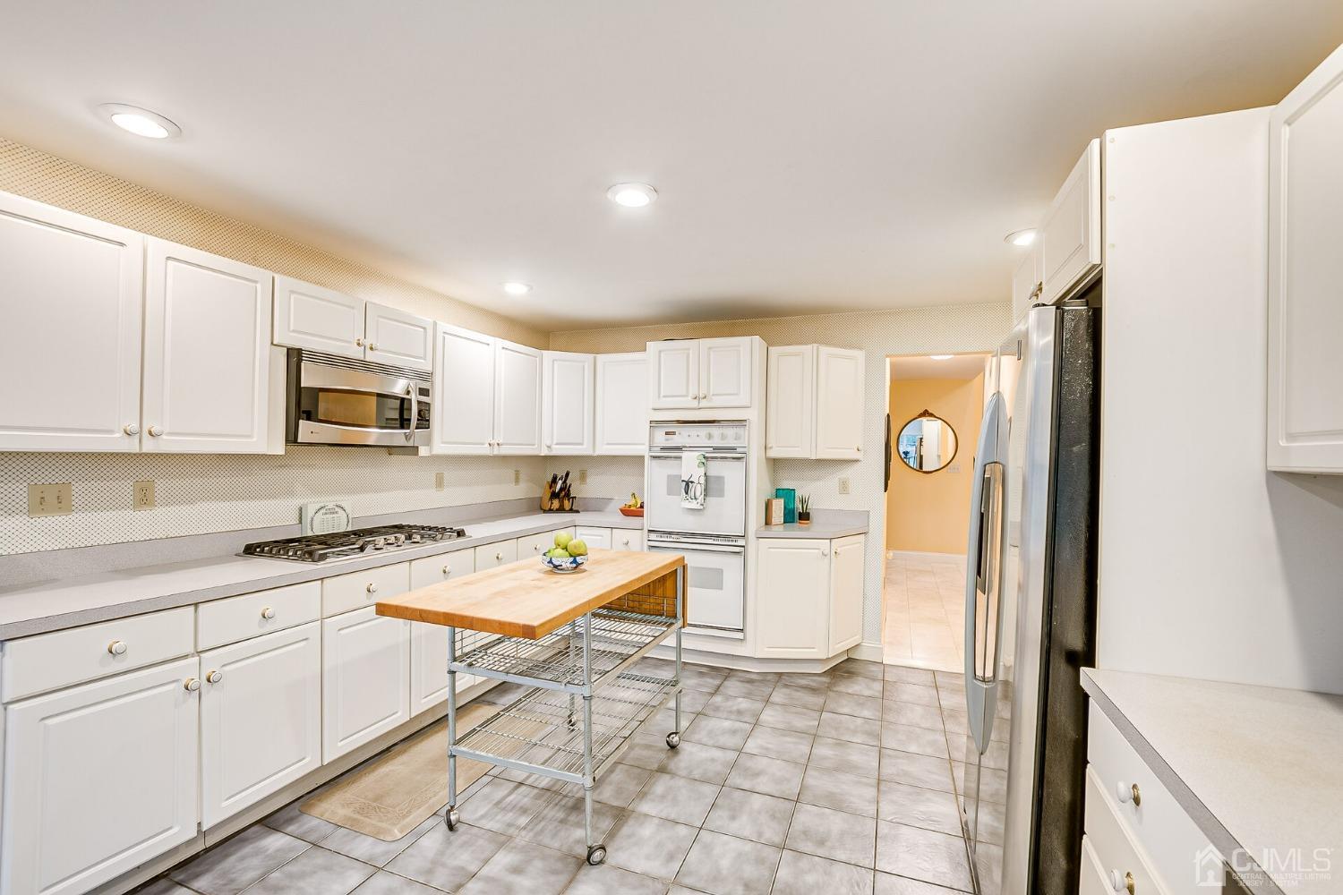 12 Clive Hills Road Edison, NJ 08820 - Photo 29 of 65 a open kitchen with a sink a stove a refrigerator and white cabinets