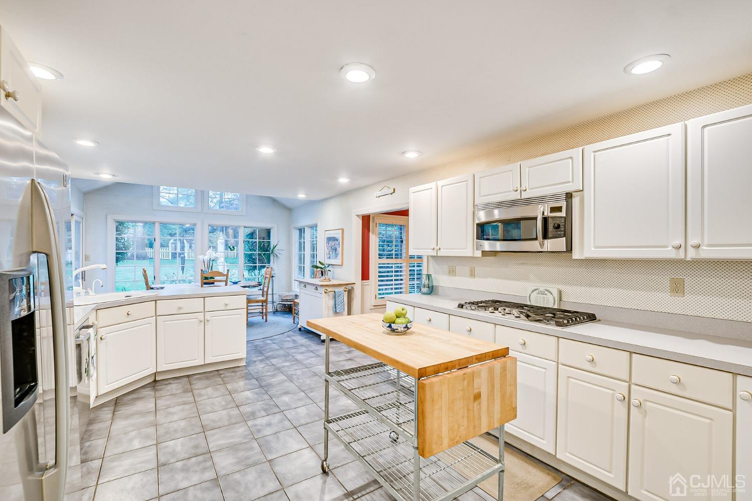 12 Clive Hills Road Edison, NJ 08820 - Photo 30 of 65 a kitchen that has a lot of white cabinets and stainless steel appliances