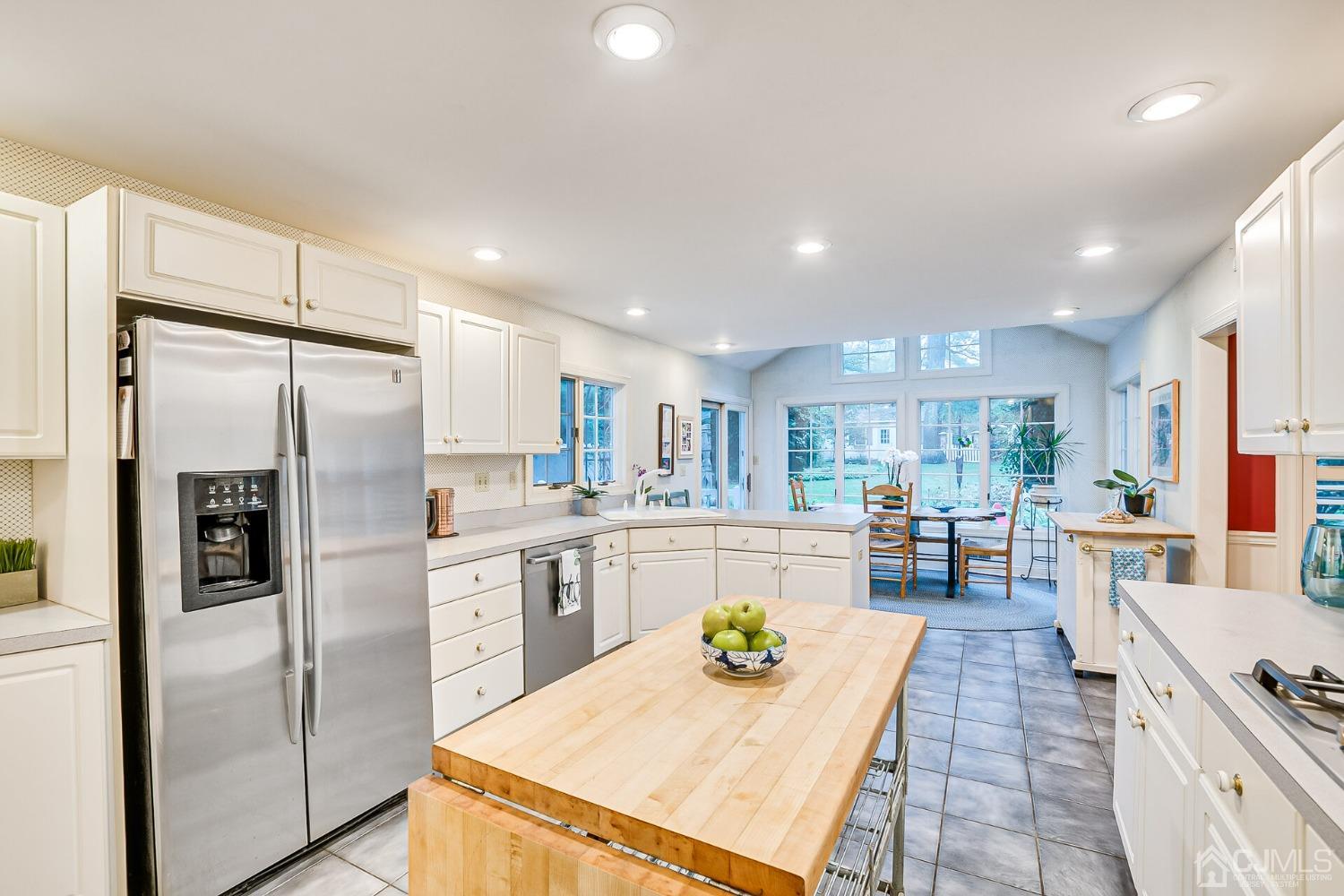 12 Clive Hills Road Edison, NJ 08820 - Photo 31 of 65 a kitchen with refrigerator and chairs