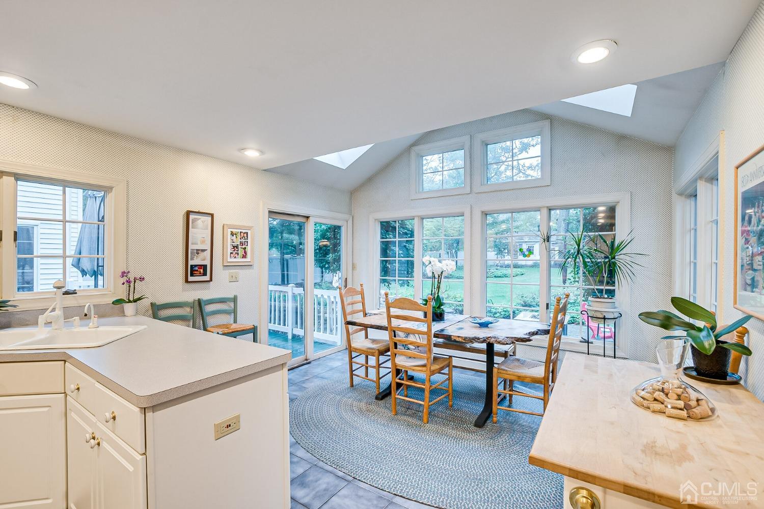 12 Clive Hills Road Edison, NJ 08820 - Photo 32 of 65 a view of a dining room with furniture and a potted plant