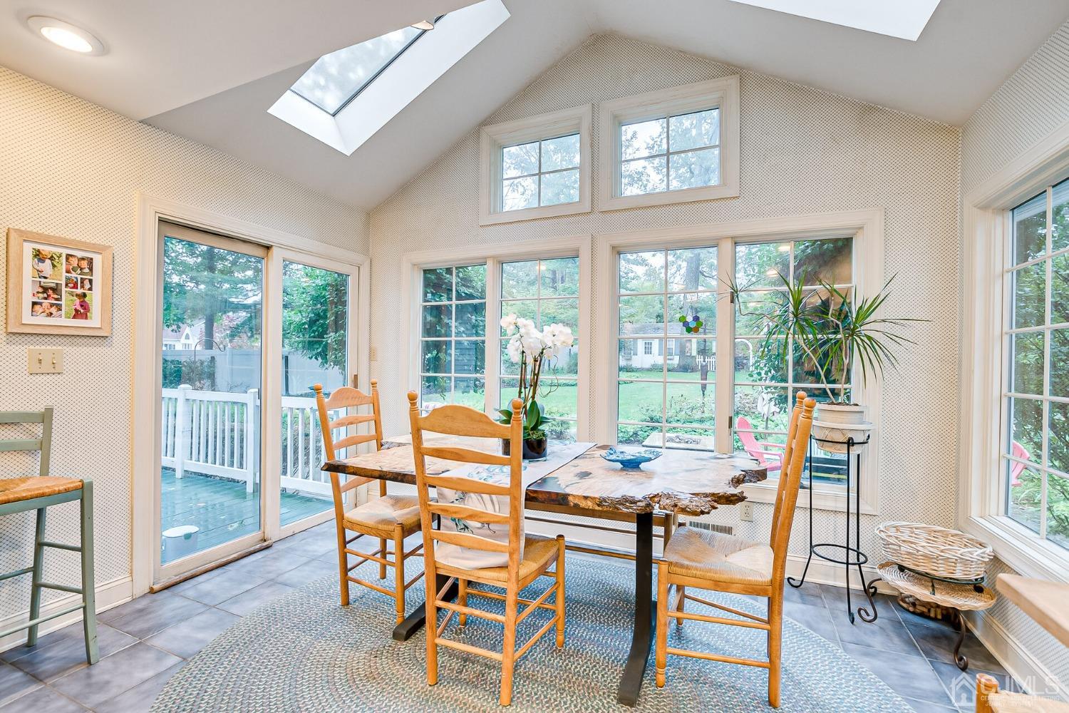 12 Clive Hills Road Edison, NJ 08820 - Photo 33 of 65 a dining room with furniture a chandelier and wooden floor