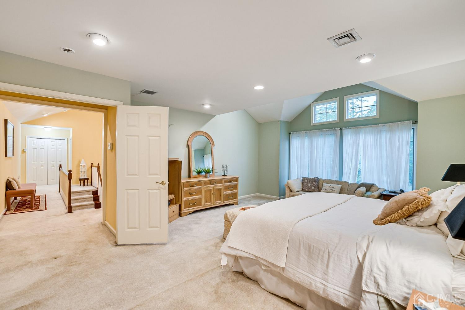 12 Clive Hills Road Edison, NJ 08820 - Photo 42 of 65 a bedroom with a large bed and a large mirror