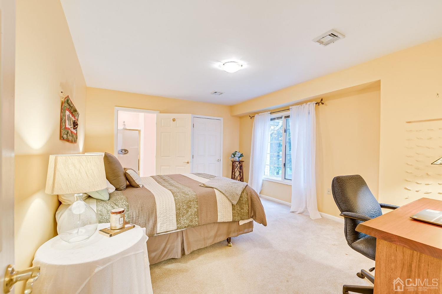 12 Clive Hills Road Edison, NJ 08820 - Photo 49 of 65 a spacious bedroom with a bed and a chair