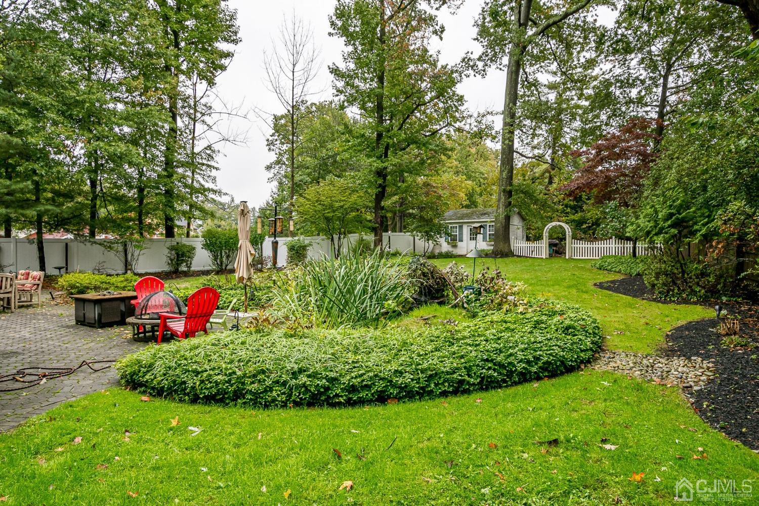 12 Clive Hills Road Edison, NJ 08820 - Photo 61 of 65 a front view of a house with swing and flower plants