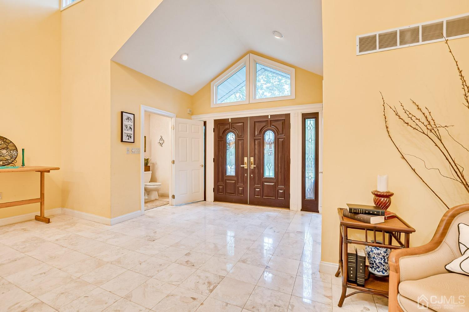 12 Clive Hills Road Edison, NJ 08820 - Photo 8 of 65 a view of a hallway with wooden floor and a bathroom