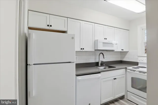 a white refrigerator freezer sitting in a kitchen
