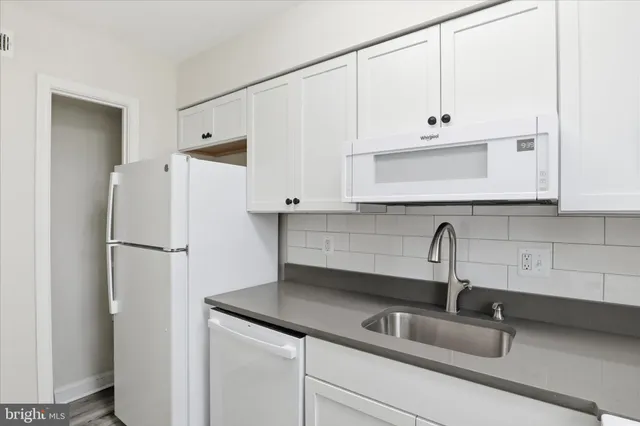 a kitchen with refrigerator a sink and cabinets