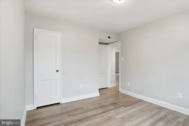 a view of an empty room and wooden floor