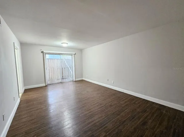 a view of an empty room and wooden floor