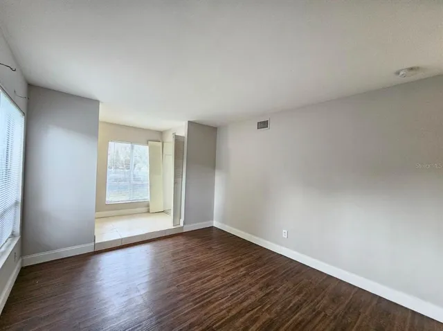 a view of wooden floor and windows in a room