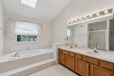 a kitchen with stainless steel appliances granite countertop a stove a sink dishwasher and a microwave oven with cabinets