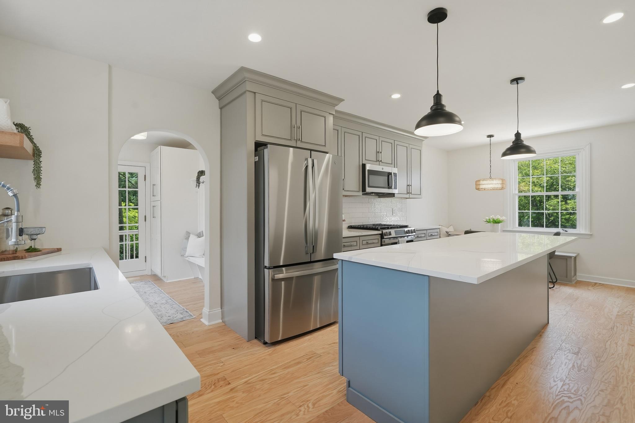 800 Pleasant Hill Road Wallingford, PA 19086 - Photo 10 of 34 a kitchen with a refrigerator a sink and wooden floor