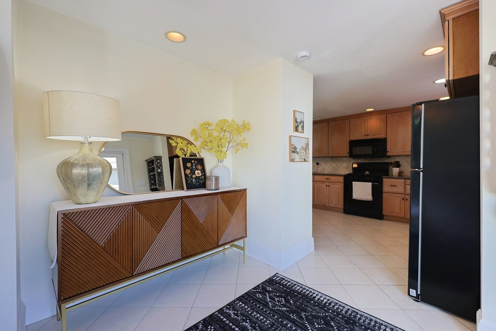 107 Minot Street Boston, MA 02122 - Photo 13 of 42 a kitchen with stainless steel appliances granite countertop a refrigerator and a sink